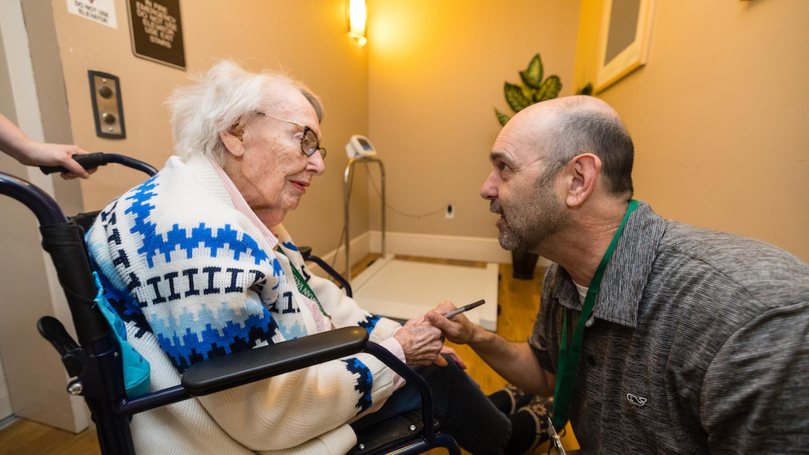 A resident in a wheelchair receiving an assessment by one of our staff.