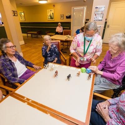 Residents sitting around a game table. 