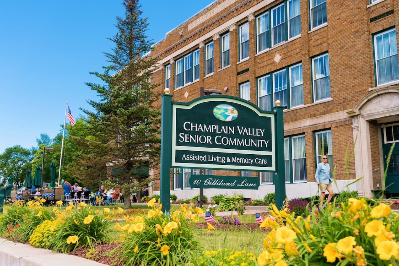 A view of the CVSC sign, surrounded by yellow flowers outside of our facility.