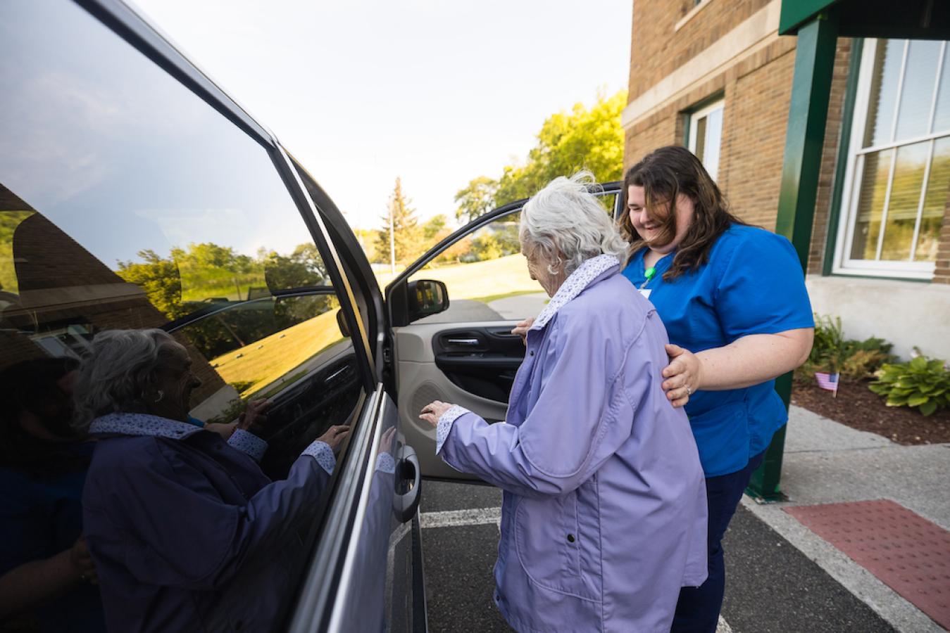 Resident entering vehicle with staff member