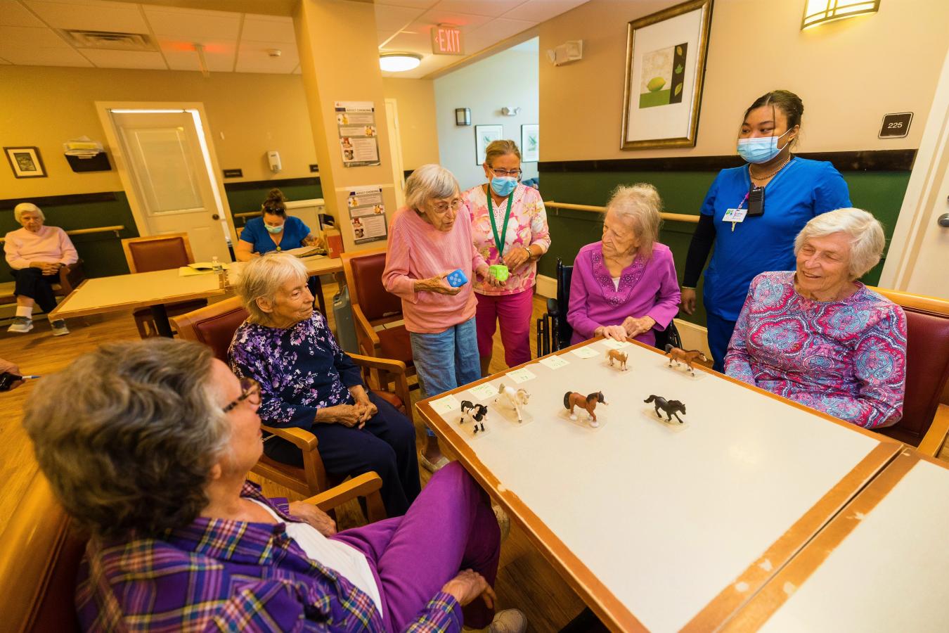 Group of residents play games around a table. 