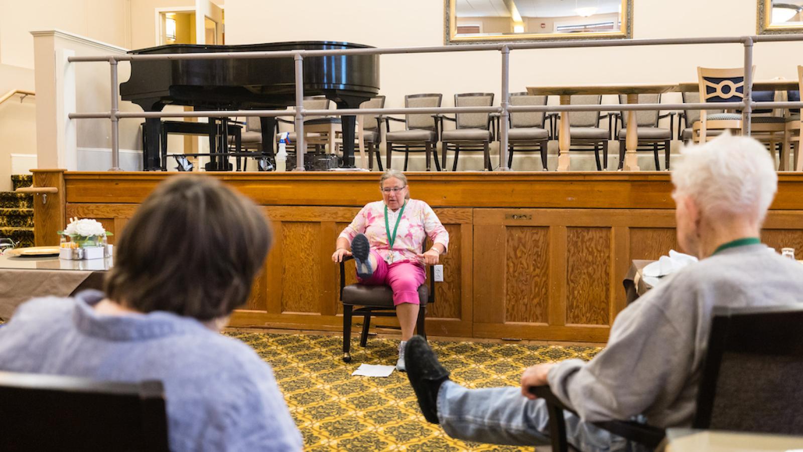 A nurse performing on-site rehab with residents.