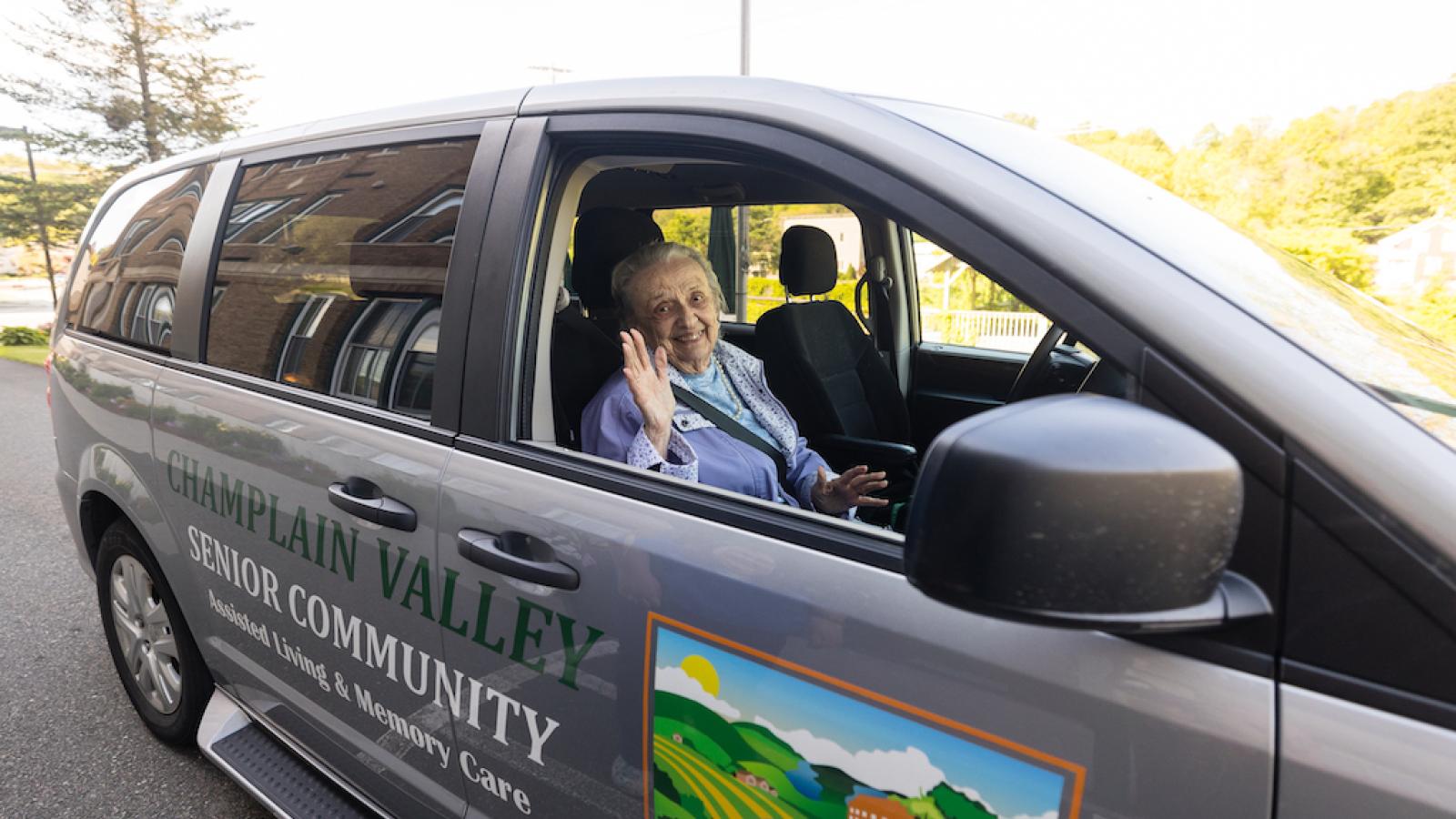 A resident in the passenger seat of the CVSC transport services gray van.