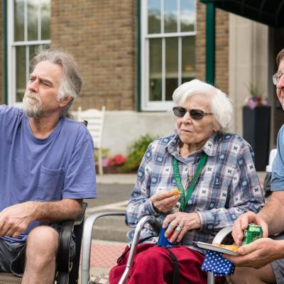 Two men with their elderly mother.