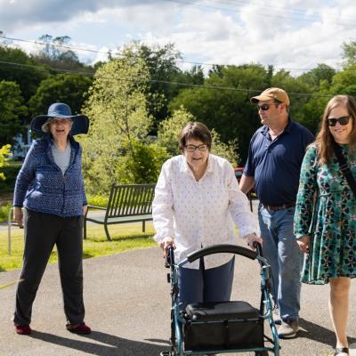 Family members walking into our assisted living facility with resident. 