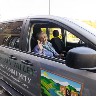 Resident waving from the front seat of the CVSC transport van. 