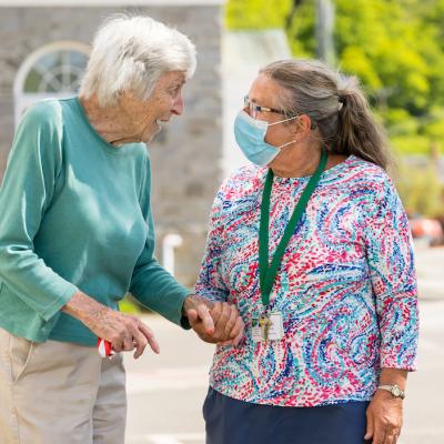 A resident outside with a skilled nurse.