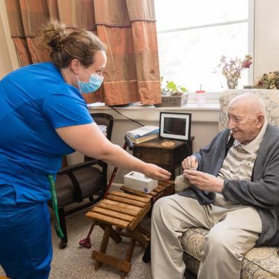 A nurse delivering medication to a resident.