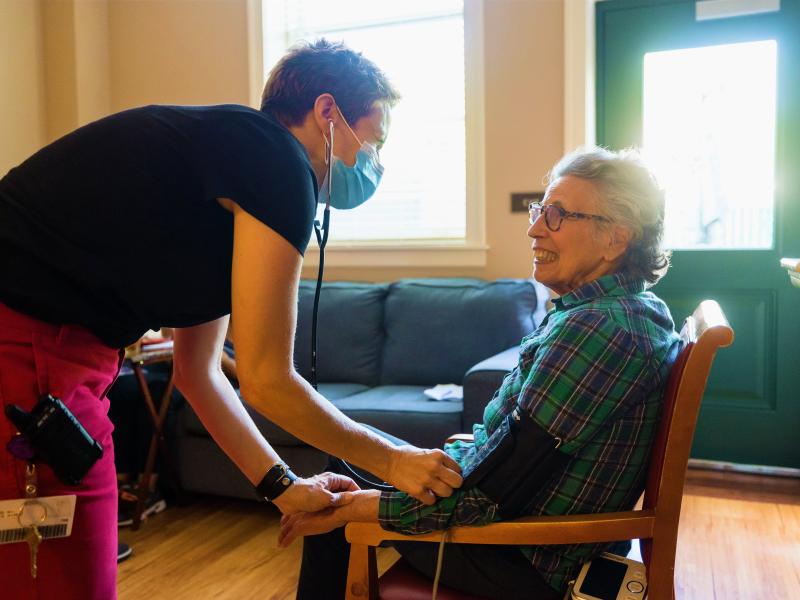 Staff providing resident with a health assessment. 